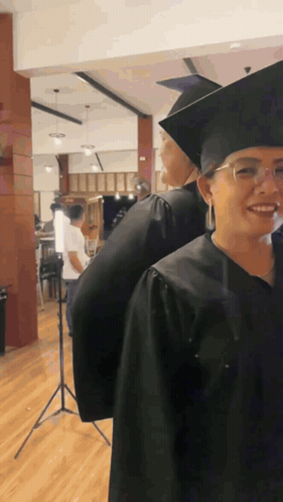 Woman In Graduation Cap And Gown Smiling GIF