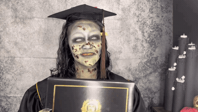 Woman In Graduation Cap And Gown With Zombie Makeup GIF