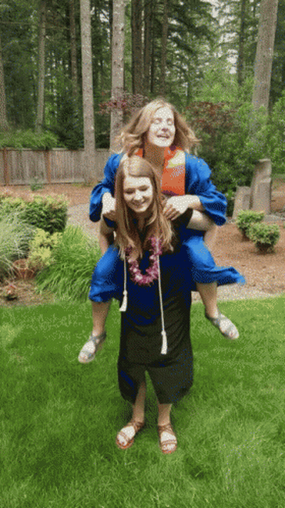 Woman In Graduation Gown Carrying Another Woman GIF