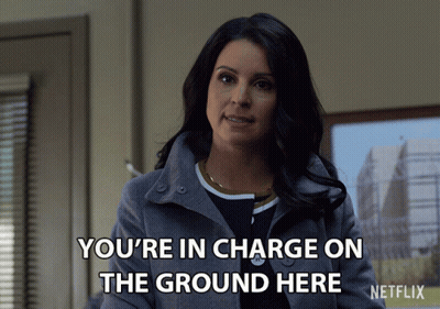 Woman In Gray Coat Says You're In Charge On The Ground Here GIF