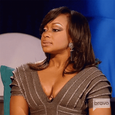 Woman In Gray Dress And Earrings Sitting On Couch Bravo TV GIF