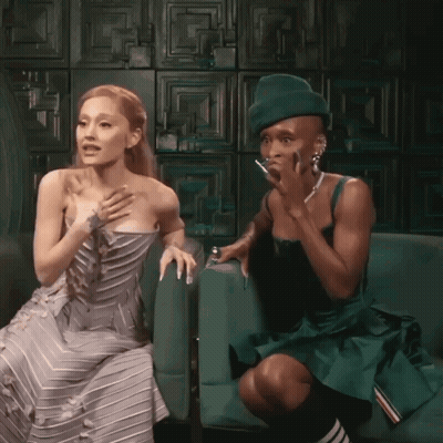 Woman In Gray Dress Next To Man In Green Dress GIF