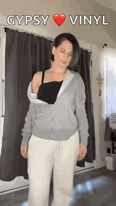 Woman In Gray Hoodie Before Gypsy Vinyl Sign GIF