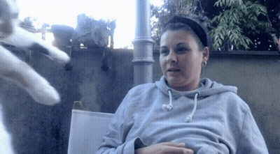 Woman In Gray Hoodie Sitting In Chair GIF