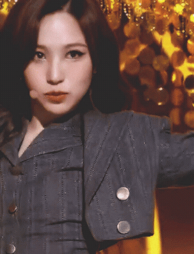Woman In Gray Jacket With White Sleeve Buttons GIF