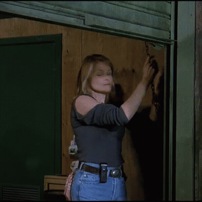 Woman In Gray Shirt And Jeans Holding Chain GIF