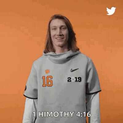 Woman In Gray Shirt With Number 16 Holding Hair GIF