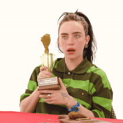 Woman In Green And Brown Striped Shirt Holding Winner Trophy GIF