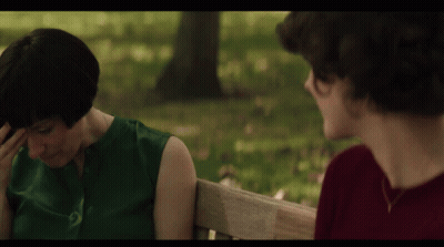 Woman In Green And Man In Red On Bench GIF
