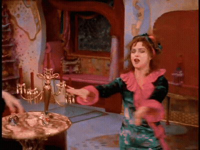 Woman In Green And Pink Dress Dancing By Candelabra GIF