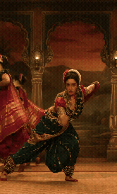 Woman In Green And Red Costume Dancing GIF