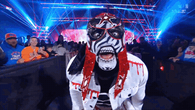 Woman In Green And White Feathered Mask GIF