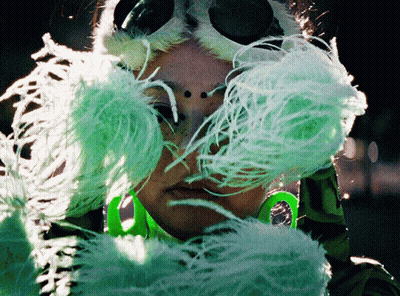 Woman In Green And White Feathered Mask GIF