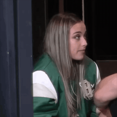 Woman In Green And White Sweater Sitting In Chair GIF