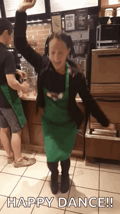 Woman In Green Apron Dancing Happy Dance GIF