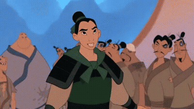 Woman In Green Armor Standing Before Group Of Men GIF