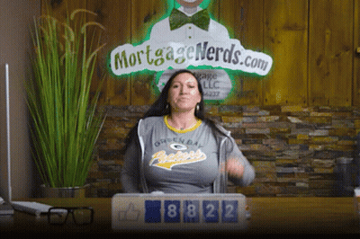 Woman In Green Bay Packers Shirt In Front Of Mortgage Nerds Sign GIF