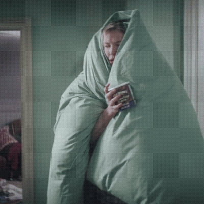 Woman In Green Blanket Holding Ben & Jerry Ice Cream GIF