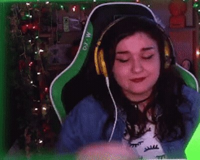Woman In Green Chair With Headphones And Letter M GIF