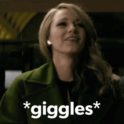 Woman In Green Coat Smiling Giggles GIF