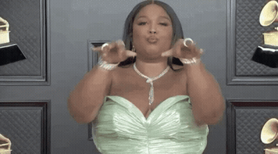 Woman In Green Dress And Necklace Giving Kiss GIF