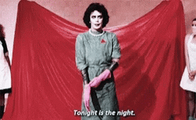 Woman In Green Dress And Pink Gloves Holding Knife GIF