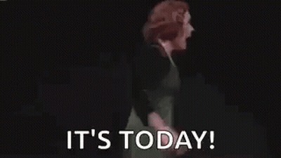 Woman In Green Dress Arms Outstretched Saying It's Today GIF