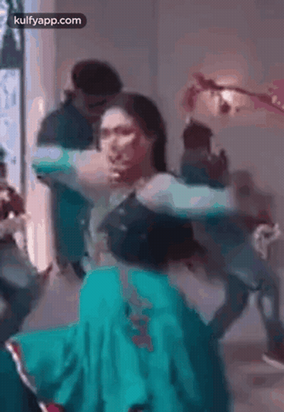 Woman in Green Dress Dancing With Man
