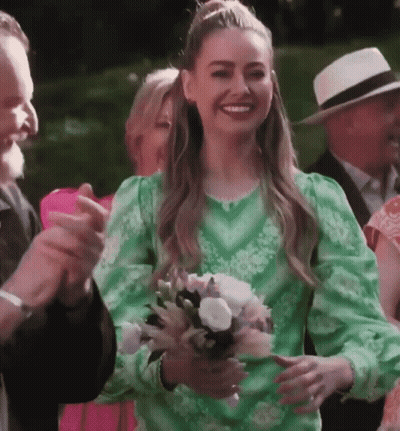 Woman In Green Dress Holding Flowers GIF