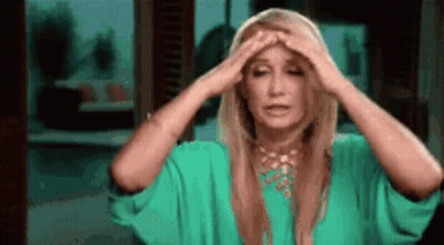 Woman In Green Dress Holding Head GIF