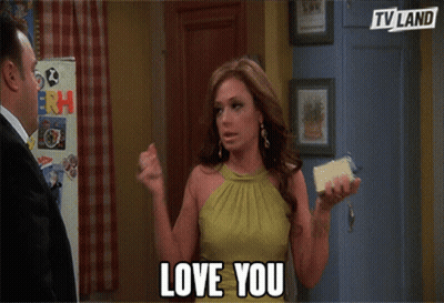 Woman In Green Dress Holding Phone Saying Love You GIF