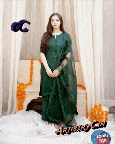 Woman In Green Dress In Front Of Couch With Flowers GIF