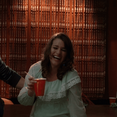 Woman In Green Dress Laughing With Red Cup GIF