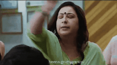 Woman In Green Dress Making Funny Face GIF