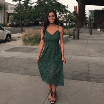 Woman In Green Dress On Sidewalk GIF