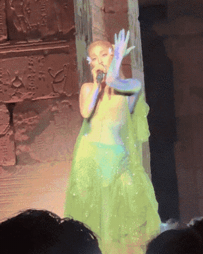 Woman In Green Dress Singing Into Microphone GIF
