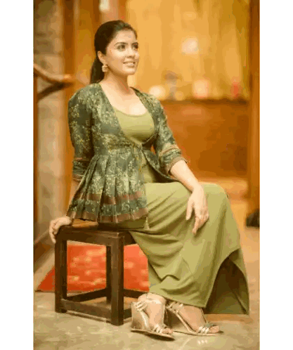Woman In Green Dress Sitting On Stool Sticker