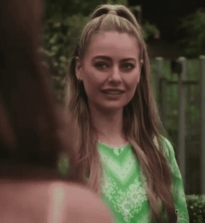 Woman In Green Dress Smiling Beside Another Woman GIF