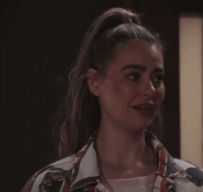 Woman In Green Dress Smiling Beside Another Woman GIF