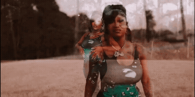 Woman In Green Dress Standing On Dirt Field GIF