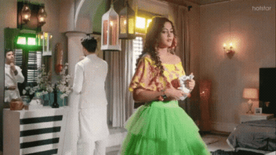 Woman In Green Dress With Man In White Suit GIF