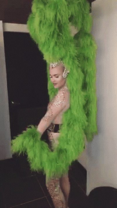 Woman In Green Feathered Costume GIF