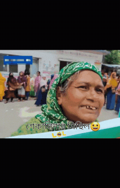 Woman In Green Head Scarf Smiling Holding Lol Sign GIF
