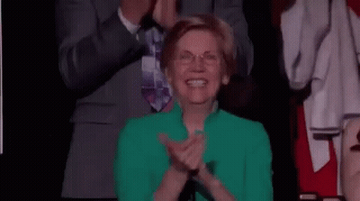 Woman In Green Jacket Applauding In Crowd GIF