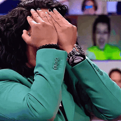 Woman In Green Jacket Covering Face With Watch GIF