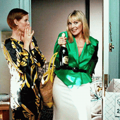 Woman In Green Jacket Holding Bottle GIF