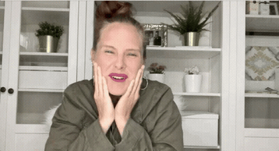 Woman in Green Jacket Making Funny Face With Hands on Face