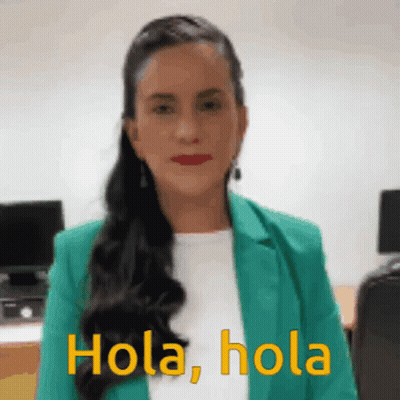 Woman In Green Jacket Saying Hola Hola GIF