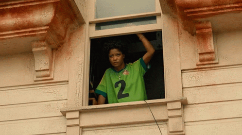 Woman In Green Jersey Looking Out Window GIF