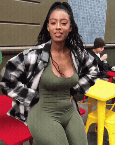 Woman In Green Jumpsuit And Plaid Jacket GIF